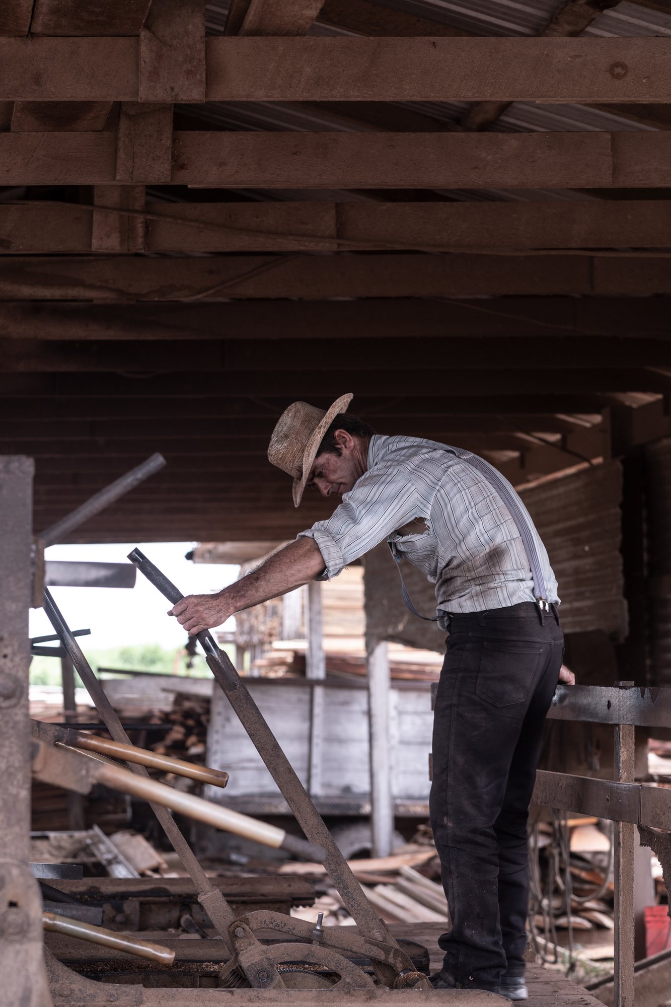 A man bent to the work of the mill