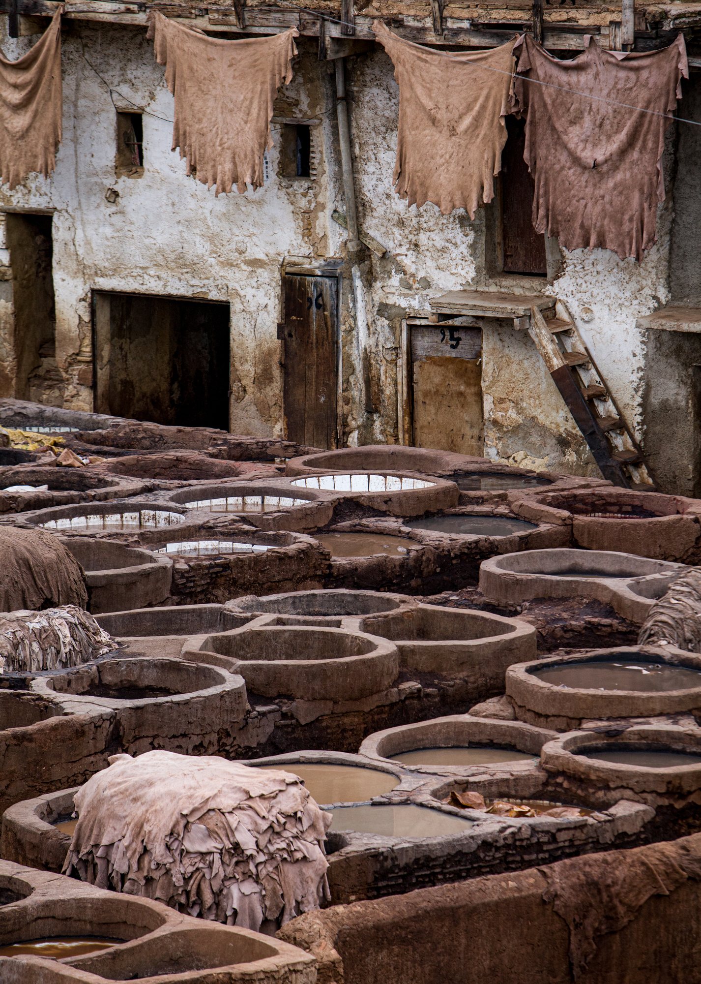 The honeycomb of stone vats, with hides stretched to dry above