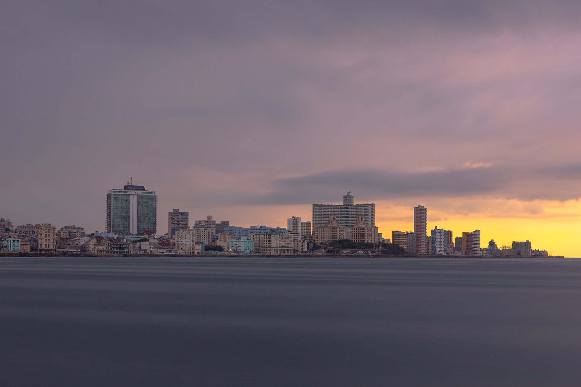 The Malecón and the skyline at the hour the light goes