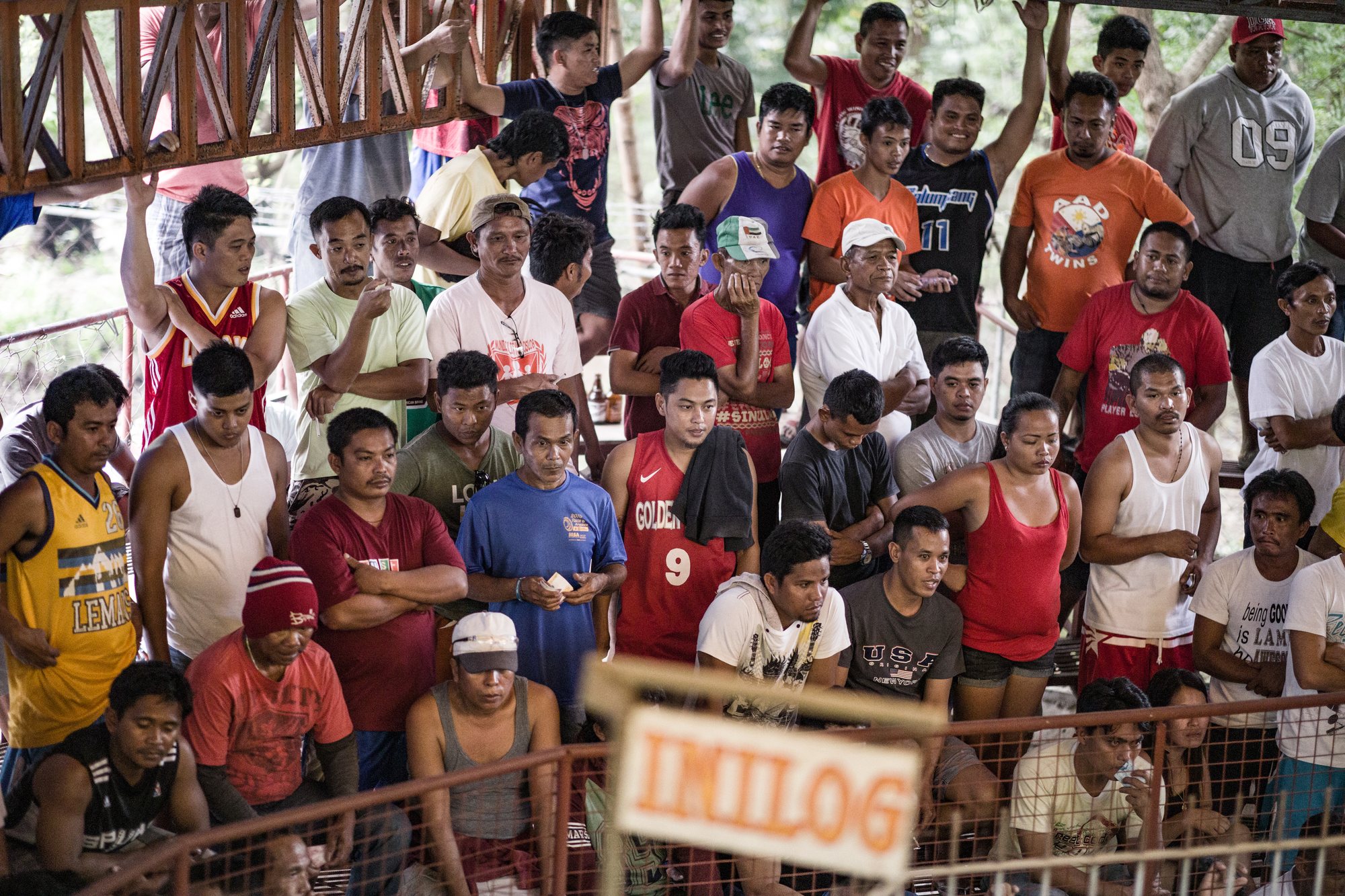 A dense crowd of spectators behind a fence at an INILOG derby
